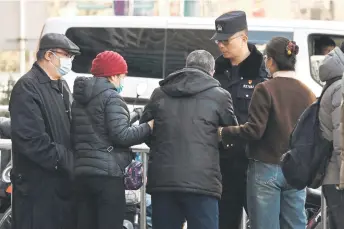  ?? ?? Relatives of passengers on board the MH370 speaking with police opposite China’s Foreign Ministry in Beijing.