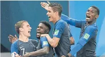 ??  ?? France’s Samuel Umtiti, second left, is congratula­ted by Antoine Griezmann, left, after scoring against Belgium.