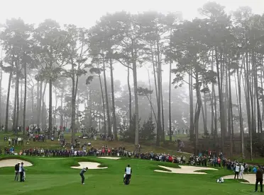  ?? — AFP ?? Poor visibility: Jordan Spieth hits his shot on the 17th hole during the foggy second round of the Pebble Beach Pro-Am at Spyglass Hill on Friday.