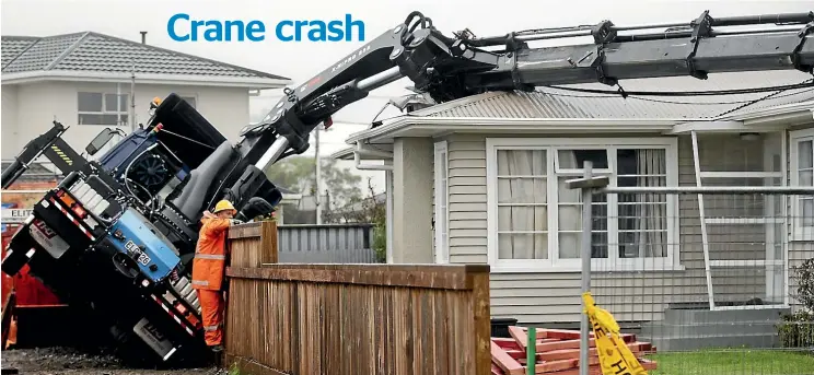  ?? ANDY JACKSON/STUFF ?? A New Plymouth building site worker surveys the damage caused when a crane crashed on to the roof of the house next door.