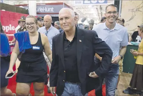  ?? Charlie Neibergall Associated Press ?? FORMER VICE PRESIDENT Mike Pence visits the Iowa State Fair on Friday. He was careful to keep his political remarks focused on the November midterm election, when Sen. Charles E. Grassley (R-Iowa) will be on the ballot, and not on the 2024 presidenti­al race.