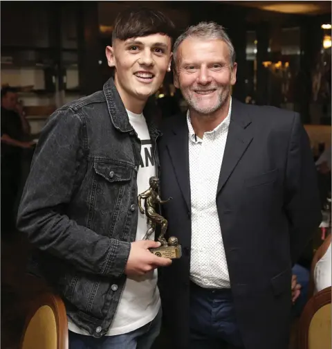  ??  ?? Player of the Year - Brandon Feely accepts Player of the Year award from manager Laurence Mahony at the Enniskerry Youth Club awards at the Powerscour­t Arms. Photo: Barbara Flynn