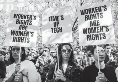  ?? JEENAH MOON / REUTERS ?? Workers hold signs after walking out of the Google offices in New York on Thursday as part of a global protest over workplace issues.