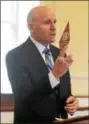  ?? PETE BANNAN — DIGITAL FIRST MEDIA ?? Chester County District Attorney Thomas Hogan holds up the Detective of the Year award. The winner was unable to accept it in public because he is an undercover officer.