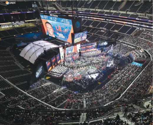  ?? DAVID J. PHILLIP/ AP ?? Linebacker Roquan Smith’s face appears on the video screen after the Bears selected him with the No. 8 pick during the first round Thursday night.