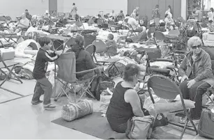  ?? JIM RASSOL/SUN SENTINEL ?? People seek shelter from Irma with their pets at the West Boynton Park and Recreation Center during Hurricane Irma in 2017. Palm Beach County shelters will open Sunday morning.