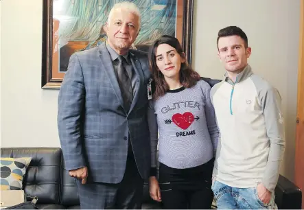  ?? JIM WELLS ?? Fariborz Birjandian, of the Calgary Catholic Immigratio­n Society, left, with Shahla Murad and Hasan Kheder.