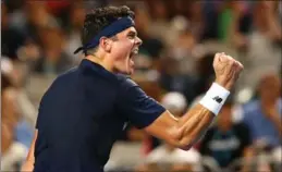  ?? JACK THOMAS, GETTY IMAGES ?? Milos Raonic of Canada celebrates match point in his third-round match against Gilles Simon of France at the Australian Open. Raonic won in four sets.