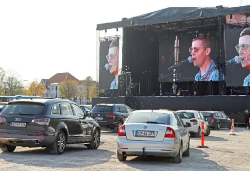  ?? Ritzau Scanpix/AFP via Getty Images ?? Danish singer and songwriter Mads Langer performs a sold-out drive-in concert at Tangkrogen in Aarhus, Denmark, on April 24.