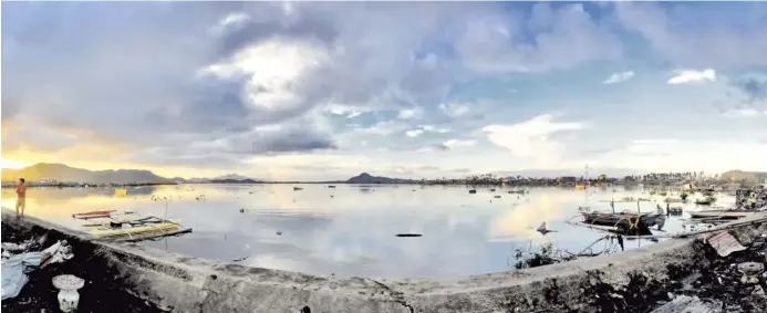  ?? KHRIZER MALIBAGO ?? Deceptive beauty Tacloban City’s Cancabato Bay bares its magnificen­ce the day after the destructiv­e typhoon “Yolanda” hit. The monster storm left debris that littered the water and its bank.