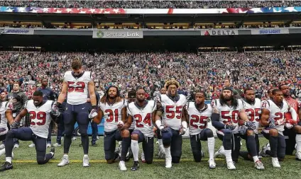  ?? Elaine Thompson / Associated Press ?? The Texans are politicall­y aware, as shown by those kneeling and standing during the national anthem Oct. 29, 2017, in Seattle.