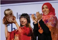  ?? — afp ?? Japanese Rena Kawasaki poses after receiving the Kidsrights nternation­al Children’s Peace Prize from the Yemeni Nobel laureate Tawakkol Karman in The Hague on Monday.