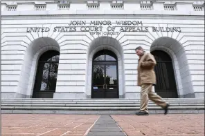  ?? (AP/Jonathan Bachman) ?? A man walks in front of the 5th U.S. Circuit Court of Appeals in New Orleans.