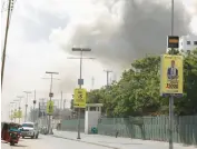  ?? HASSAN ALI ELMI/GETTY-AFP ?? Smoke rises Saturday over the Somali capital of Mogadishu after two car bombings.