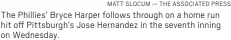  ?? MATT SLOCUM — THE ASSOCIATED PRESS ?? The Phillies’ Bryce Harper follows through on a home run hit off Pittsburgh’s Jose Hernandez in the seventh inning on Wednesday.