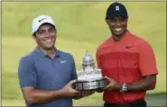  ?? NICK WASS — THE ASSOCIATED PRESS ?? Francesco Molinari, left, of Italy, poses with Tiger Woods and the trophy after he won the Quicken Loans National golf tournament, Sunday in Potomac, Md.