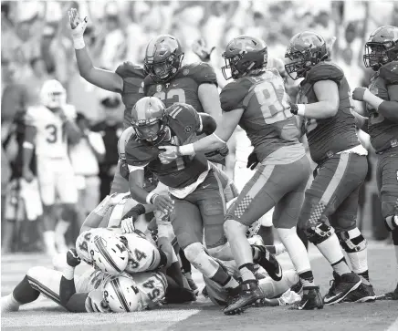  ?? STAFF PHOTO BY ROBIN RUDD ?? Tennessee quarteback Joshua Dobbs, center, comes up from the pile after scoring Tennessee’s final touchdown in Saturday’s comeback win against Florida in Knoxville.