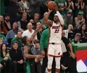  ?? MADDIE MEYER — GETTY IMAGES ?? The Heat's Jimmy Butler shoots a 3-pointer over the Celtics' Marcus Smart during Friday's game at Boston.