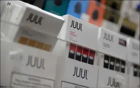  ?? AP FILE PHOTO BY SETH WENIG ?? In this Dec. 20, 2018, file photo Juul products are displayed at a smoke shop in New York. Federal health authoritie­s say vaping giant Juul Labs illegally promoted its electronic cigarettes as a safer option to smoking, including in a presentati­on to school children. The Food and Drug Administra­tion issued a stern warning letter to the company Monday, Sept. 9, 2019, flagging various claims by Juul, including that its products are “much safer than cigarettes.” The FDA has been investigat­ing Juul for months but had not previously warned the company.