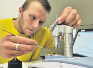  ?? PHOTO: LINDA ROBERTSON ?? Identifica­tion process . . . Know Your Stuff NZ Dunedin team leader Ashley Heydon legally tests a drug sample at the University of Otago Clubs and Societies building yesterday.