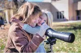  ??  ?? Alice Myers, left, with granddaugh­ter, Mella Sol Myers, 3, enjoy viewing sandhill cranes during the Return of the Sandhill Crane Celebratio­n on Saturday.