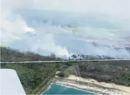  ?? FLORIDA FOREST SERVICE ?? An aerial view shows smoke from a large brush fire in south Miami-Dade County that has shut down Card Sound Road leading into the Keys on Monday.