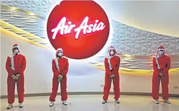  ??  ?? An image from the Instagram account of the Philippine designer Puey Quinones shows the PPE uniforms he designed for AirAsia flight attendants.
