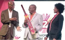  ?? RICARDO MAKYN/MULTIMEDIA PHOTO EDITOR ?? Antigua’s Minister of Sport Chet Greene (centre) at the symbolic handover of a bat to the government yesterday. Looking on are Member of Parliament Colin James (left) and Jennifer Nero, tournament director of the ICC Women’s World Twenty20 World Cup.