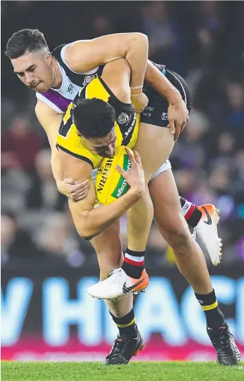  ?? Picture: GETTY IMAGES ?? HOLDING THE ... Saint Jade Gresham tackles Richmond’s Ivan Soldo yesterday.