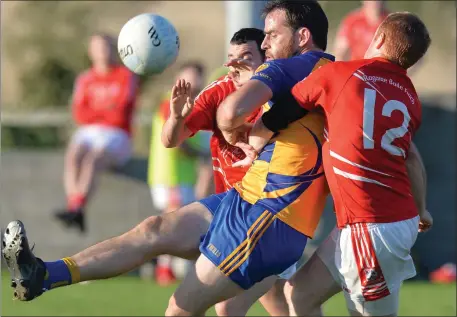  ??  ?? Shane Lennon, Kilkerley gets the ball away despite the attention of Hunterstow­n’s Brendan Lennon. Pictures: Ken Finegan