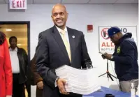  ?? ASHLEE REZIN/SUN-TIMES FILE ?? Clayton Harris III, a former prosecutor and political aide, files nominating petitions with the Cook County clerk’s office last November.