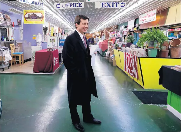  ?? NAM Y. HUH/AP ?? Mayor Pete Buttigieg walks around as he talks with people at Farmers Market in South Bend on Jan. 10.