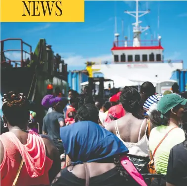  ?? BRENDAN SMIALOWSKI / AFP / GETTY IMAGES ?? Hurricane Dorian survivors board a cargo ship in Marsh Harbour, Great Abaco, for evacuation to Nassau on Saturday.