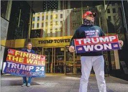  ?? Ed Jones AFP/Getty Images ?? SUPPORTERS OF former President Trump are seen outside Trump Tower in New York City on Monday. Trump said he expects to be “arrested” soon.