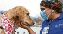  ??  ?? Joy and nurse Sonia Irby share a moment. Handlers say the dogs make it easier for people needing comfort to open up.