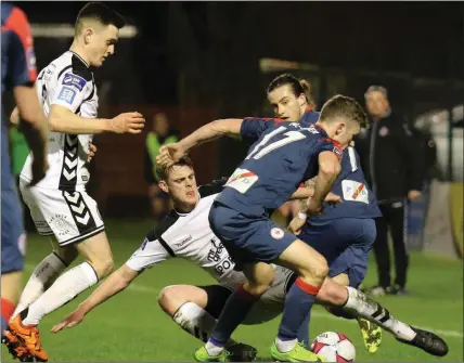  ??  ?? Caolan McAleer is challenged by Ian Morris. Pic: Martin Doherty.