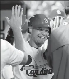  ??  ?? HIGH PRAISE: Yadier Molina gets high- fives from St. Louis teammates after driving in a run and scoring in the sixth inning of the Cardinals’ 4- 2 win over the visiting Pittsburgh Pirates Wednesday night. Molina tripled, doubled and stole a base,...