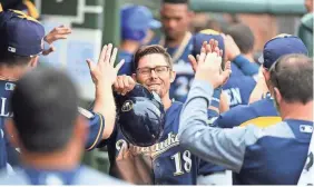  ?? NORM HALL / GETTY IMAGES ?? Eric Sogard celebrates with teammates in the dugout after scoring on a double by Hernan Perez during the fifth inning of a spring training game against the Kansas City Royals at Surprise Stadium on Wednesday.
