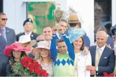  ??  ?? The connection­s of Derby winner Always Dreaming, including jockey John Velazquez ( holding trophy), rejoice in the winner’s circle.
| GETTY IMAGES