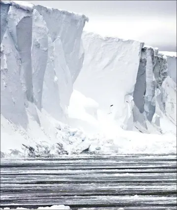  ??  ?? This undated handout picture released by the Pew Charitable Trust shows an ice wall in East Antarctica. — AFP photo