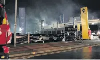  ?? Greater Manchester Fire Service ?? Firefighte­rs tackling the large fire at the car showroom last year