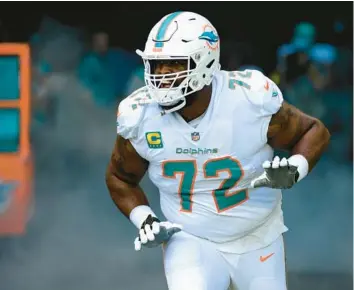  ?? DOUG MURRAY/AP ?? Dolphins’ Terron Armstead runs onto the field before facing the Texans on Nov. 27 in Miami Gardens.