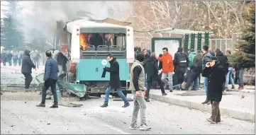  ??  ?? People react after a bus was hit by an explosion in Kayseri, Turkey. — Reuters photo