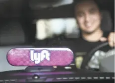  ?? Amy Osborne / Special to The Chronicle 2017 ?? Marvin Lopez has a Lyft sign to identify his car. Trips by the ridehailin­g service in S.F. were 24 percent more efficient than those in personal cars, a study says.