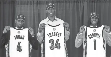  ??  ?? Grizzlies draft picks, from left, Sam Young (36th pick), Hasheem Thabeet (second) and DeMarre Carroll (27th) hold up their new team jerseys at a press conference June 26, 2009. FILE / AP