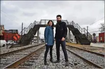  ?? HYOSUB SHIN / HSHIN@AJC.COM ?? College Park residents Whitney (left) and Micah Stansell have been commission­ed to transform the Hapeville Pedestrian Bridge, visible in the background, into a public art installati­on.