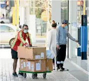  ?? GETTY IMAGES ?? Contactles­s business – a courier delivers packages in the CBD.