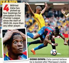  ??  ?? GOING DOWN: Zaha cannot believe he is booked after Mariappa’s tackle