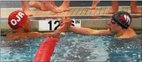  ?? AUSTIN HERTZOG - DIGITAL FIRST MEDIA ?? Race winner Jordan Roach, left, of Owen J. Roberts, and Boyertown runner-up Owen Miller congratula­te one another after competing in the 100 butterfly.