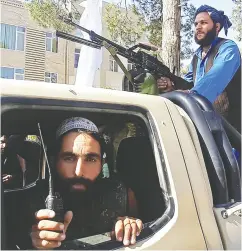  ?? AFP VIA GETTY IMAGES ?? Taliban fighters ride in a vehicle Friday in Herat, Afghanista­n’s third biggest city, after government forces pulled out following weeks of being under siege.